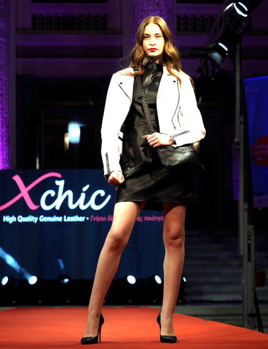 White leather Bianca biker jacket with black details from Xchic Pelle, showing the full front view and silver hardware accents.