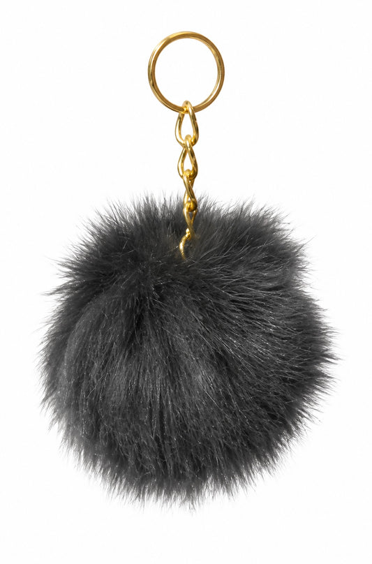 Xchic Pelle luxury fur pom pom bag and key charm featuring a soft, fluffy fur pom pom and sleek design.