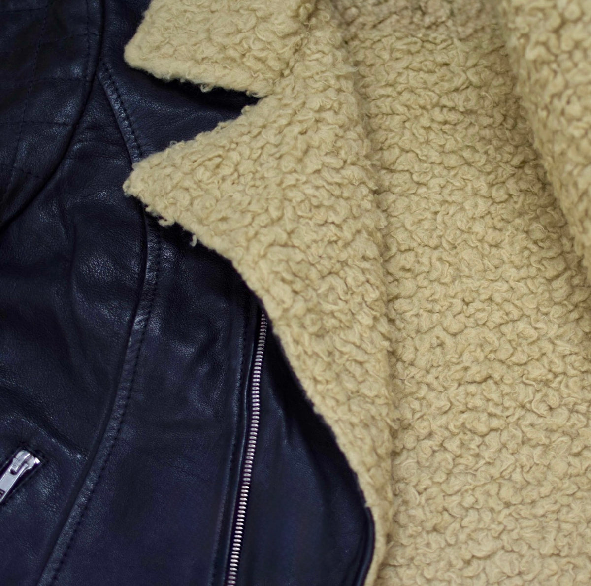 Black leather aviator Sheppskin jacket with shearling lining from Xchic Pelle, showcasing the full front view of the Stella jacket.